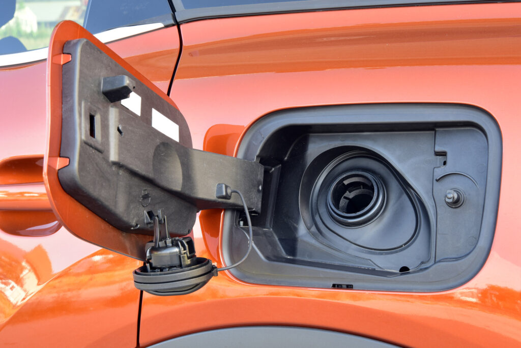 orange car with oil filler cap removed