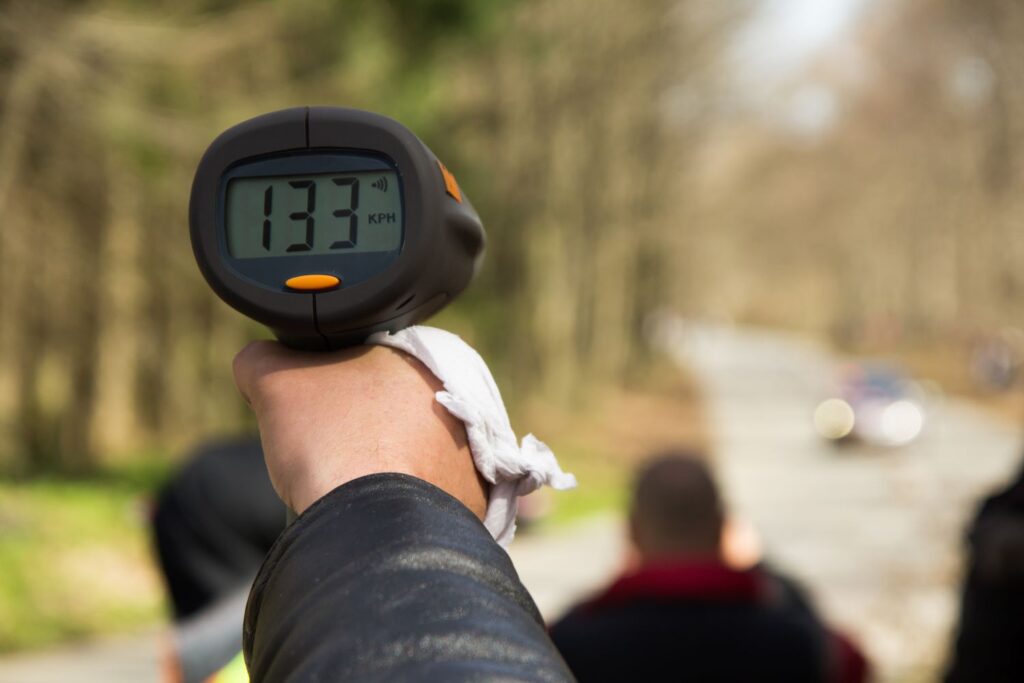 police using a speedometer to an approaching vehicle