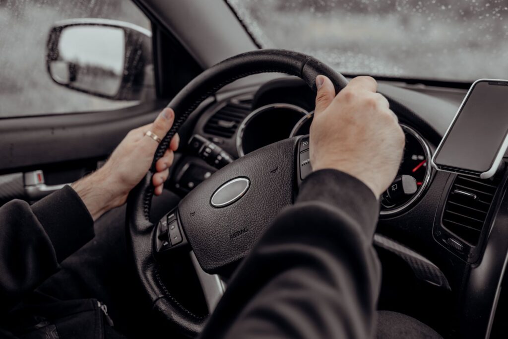 driver's hands on the steering wheel