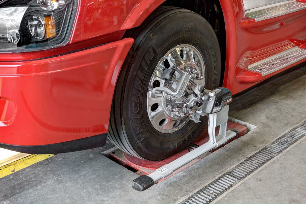 red car getting a tire alignment