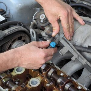 mechanic checking car fuel injector