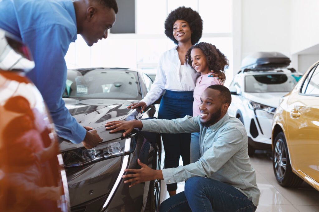 family looking for new car at dealership