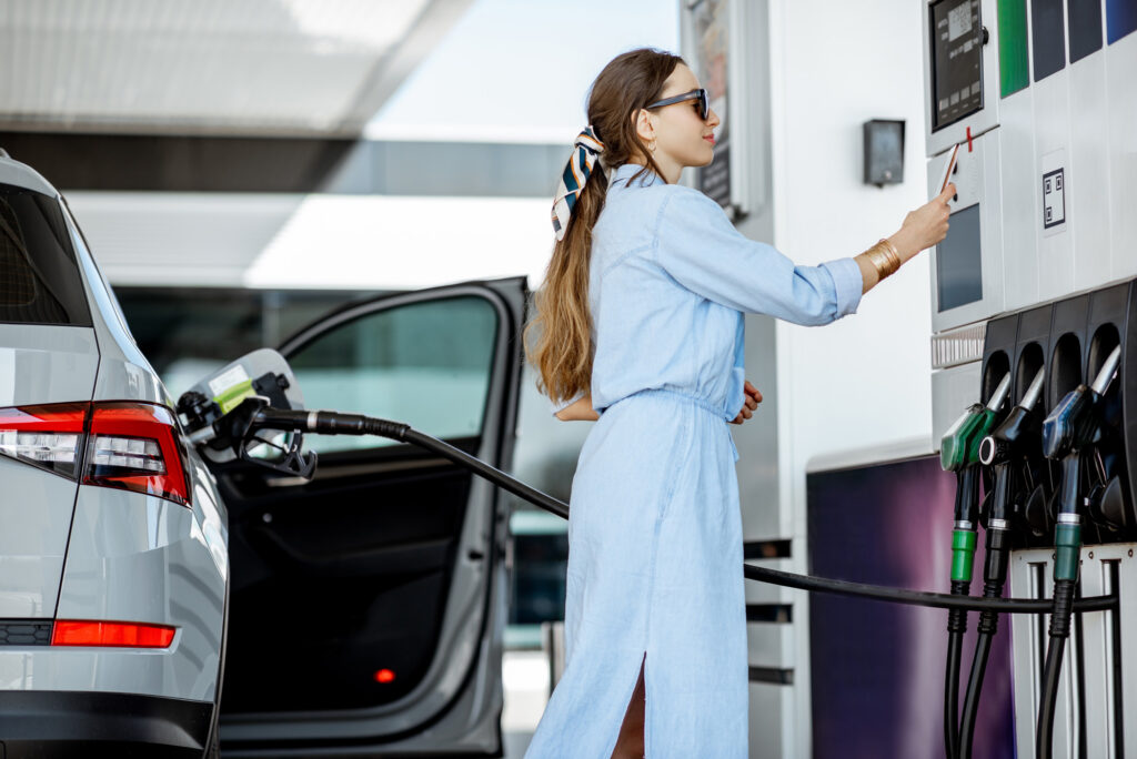 female driver paying for her car fuel