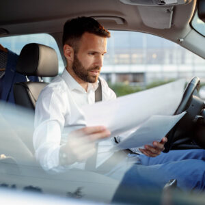 man checking papers about car lien