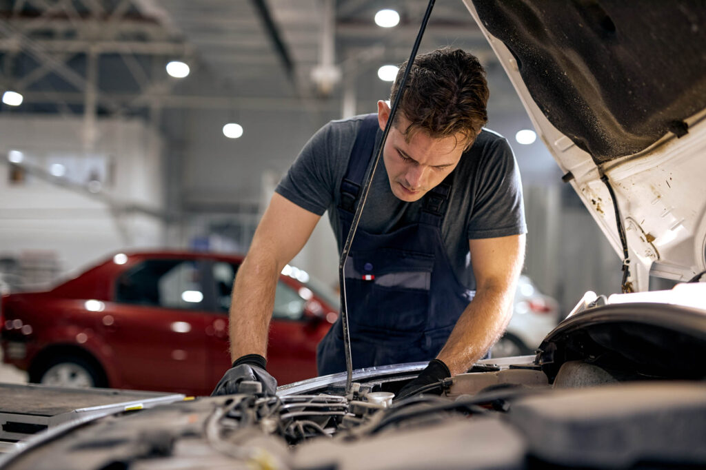 Professional,Handsome,Mechanic,In,Uniform,Is,Working,In,Auto,Service.