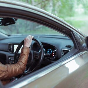 female driver checking the blind spots of her car