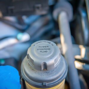 close up shot of a power steering fluid reservoir