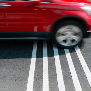 car crossing over rumble strips