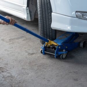 mechanic jacking up a car