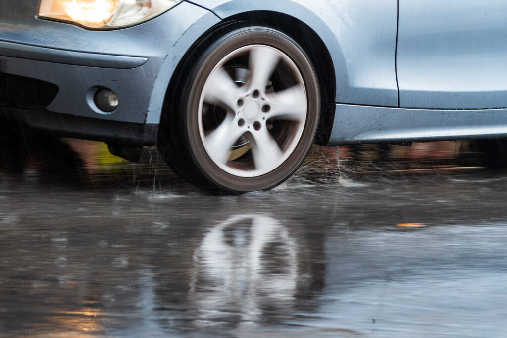 car driving on wet pavement