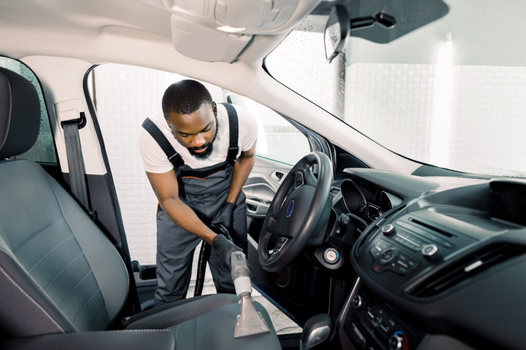 man cleaning car interior to avoid moisture