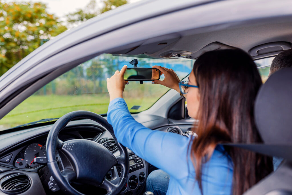 woman fixing car rear view mirror