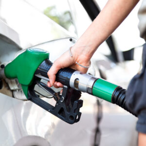 woman pumping gas to car