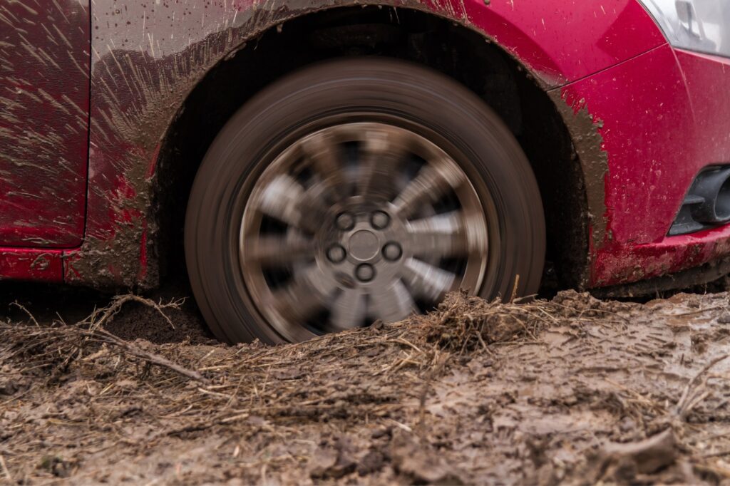 driver stuck in mud hitting gas pedal