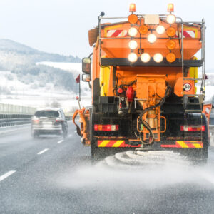 truck spreading road salt during winter