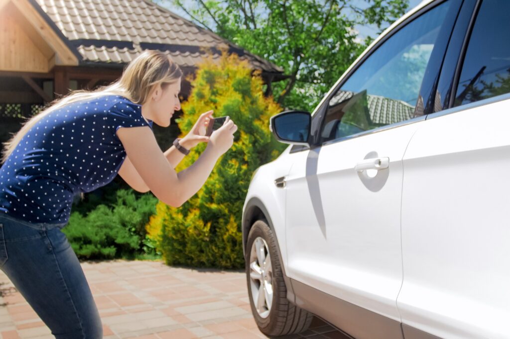 woman taking car photos