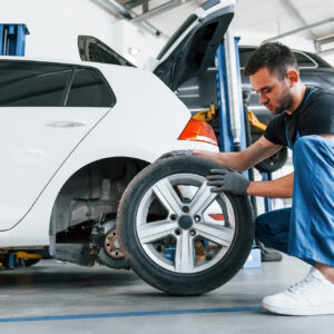 man replacing one car tire