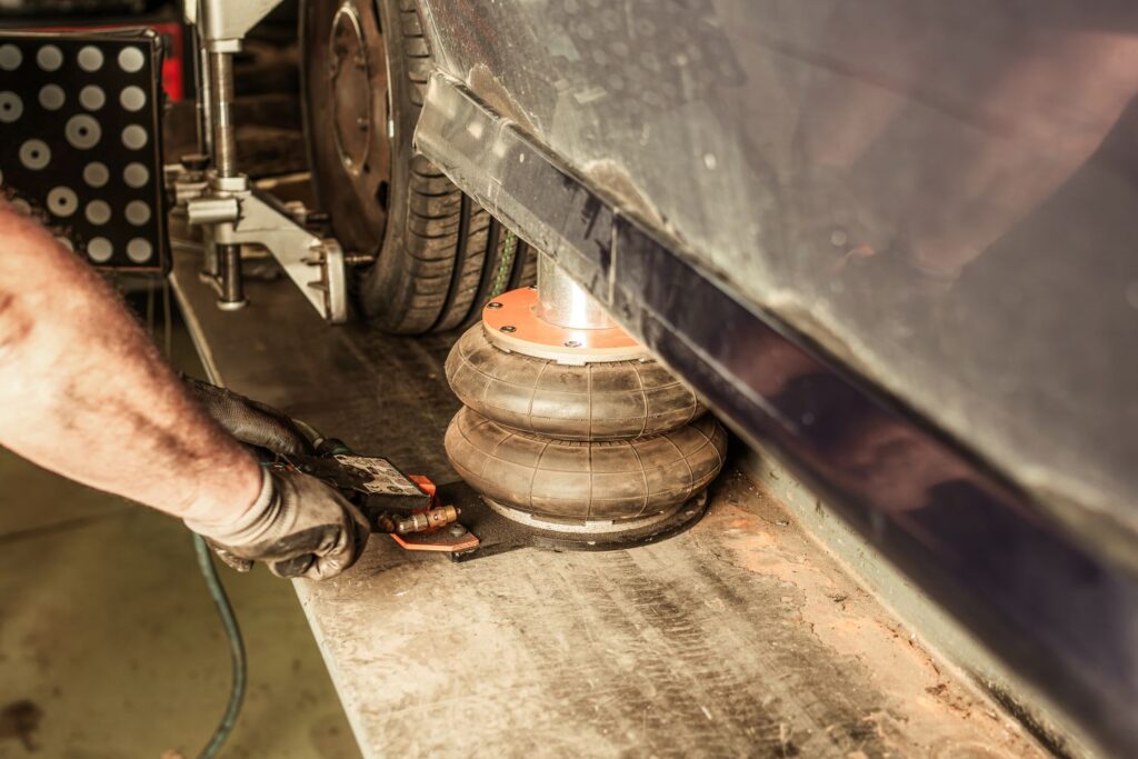 pneumatic pressure jack beneath a car