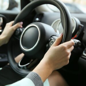 female driver holding the steering wheel