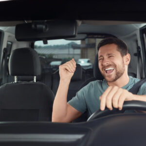 driver listening to music through car speakers