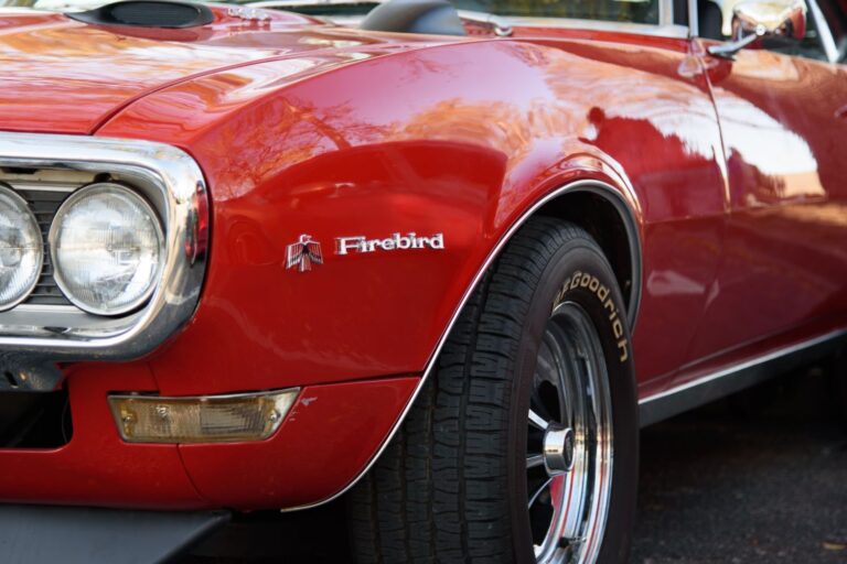 close up shot of a firebird logo on a red pontiac