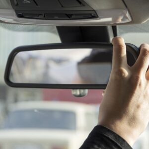 hand adjusting rear view mirror