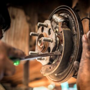 mechanic adjusting drum brake