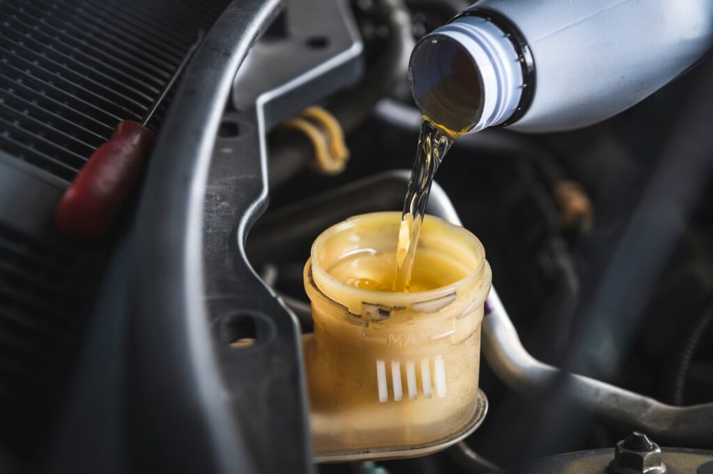 filling dot 4 brake fluid in brake fluid reservoir