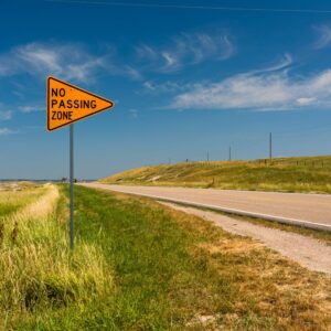 no passing zone sign in a rural road