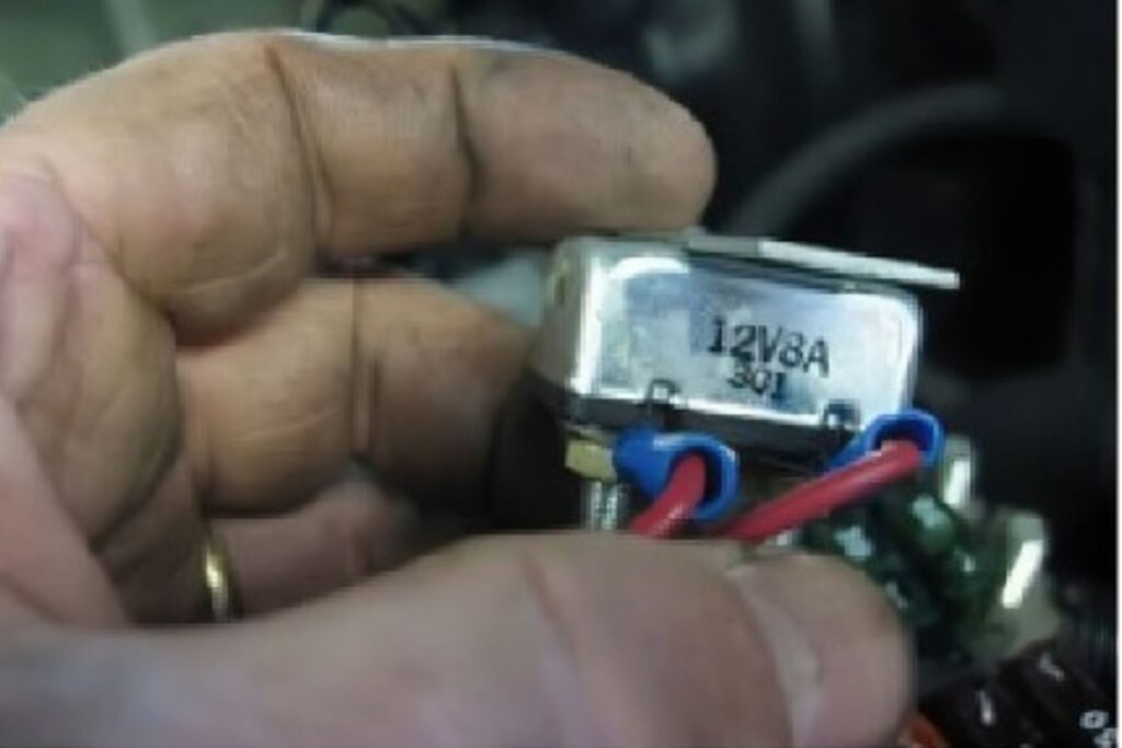 hand holding a car circuit breaker