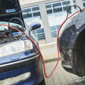 two cars jumpstarting a car battery