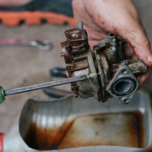 mechanic cleaning a carburetor