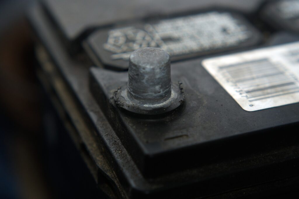 close up of car battery negative terminal