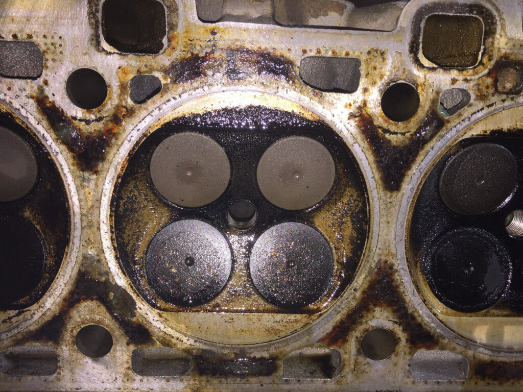 four valve engine cylinder head with carbon deposit