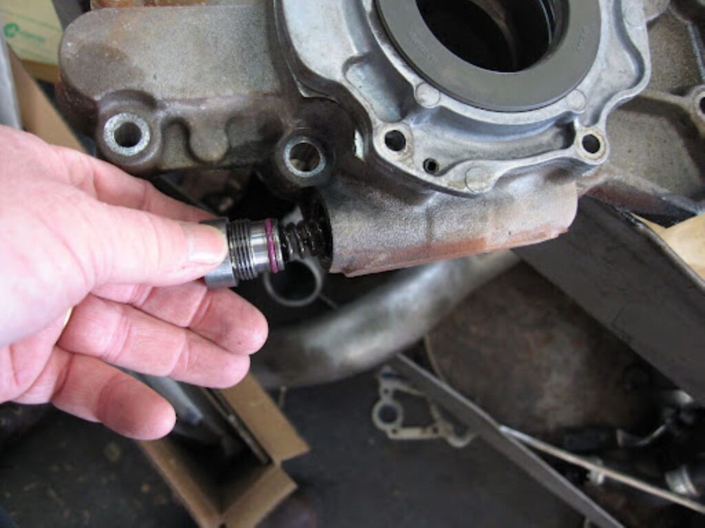 mechanic showing an oil pressure relief valve spring