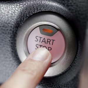 finger pressing the push start button