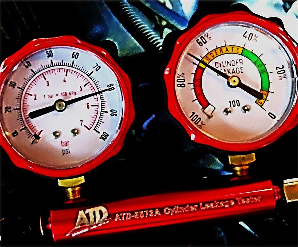 two gauge tester is being used to determine cylinder leakage