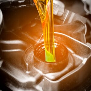 pouring an automotive engine oil