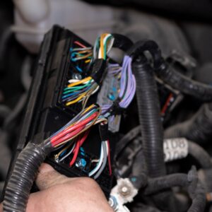 mechanic hand checking car wiring