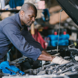 man inspects oil catch can