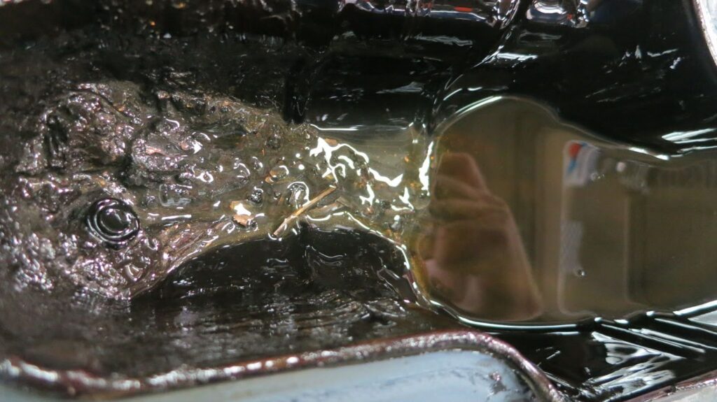 oil pan from a nissan titan that came in with a cracked flywheel making so much noise