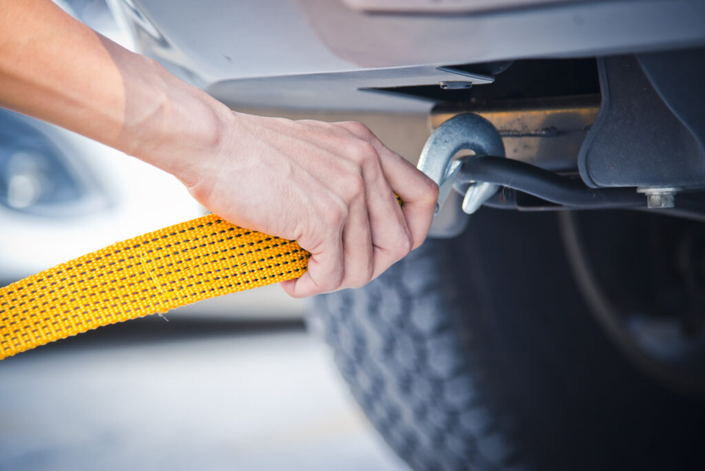 yellow towing strap being attached