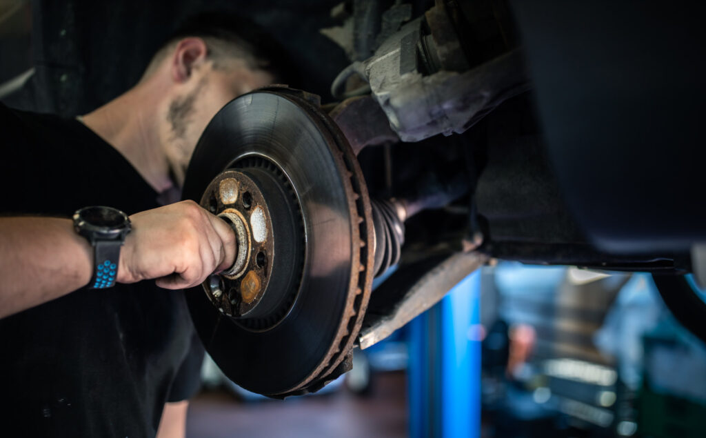 man checking noise from wheel bearing