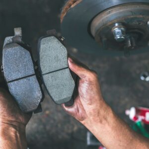 old and new brake pads of a car