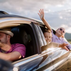 family driving with windows down