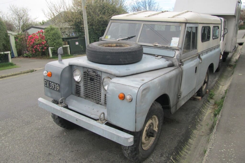 old land rover with hood spare tire