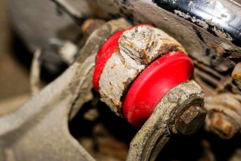 red polyurethane bushing attached to a  car component