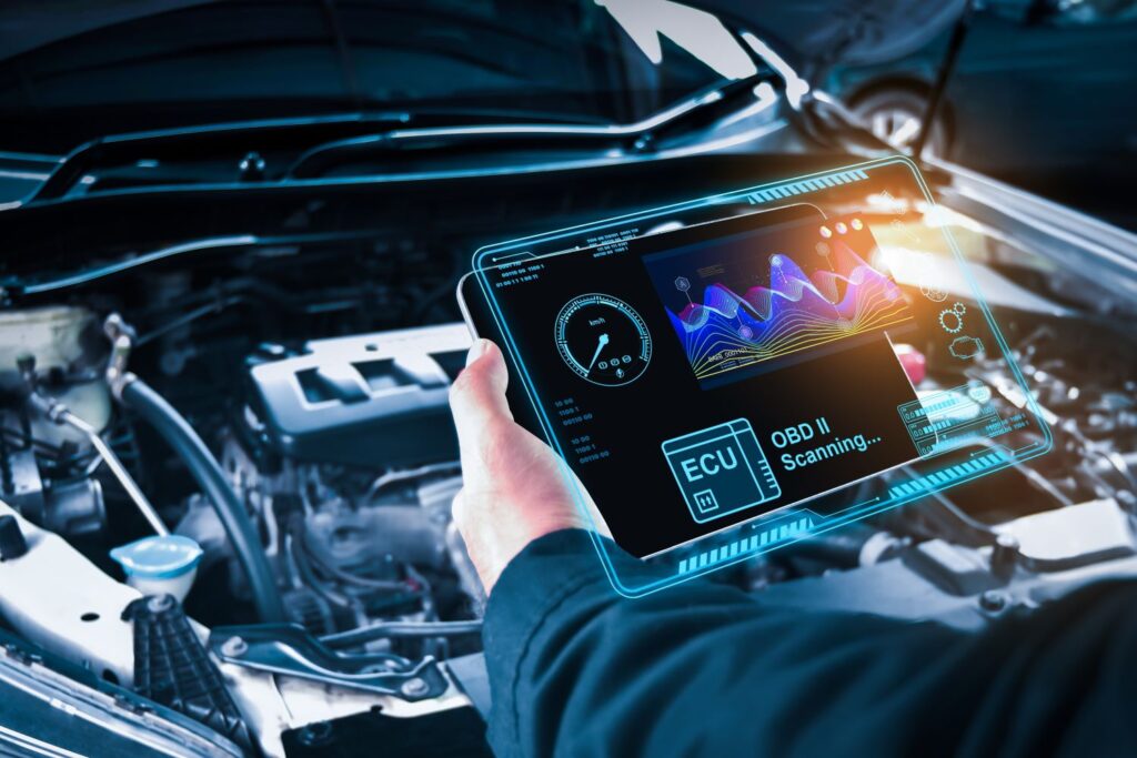 mechanic holding a car computer to update ecu