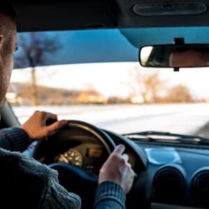 man wearing sweater inside a car