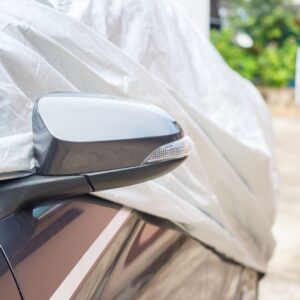 covered car with side mirror exposed